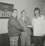Dr. Bunte presenting Sigma Kappa Phi Fraternity with check, 1975 by Franklin University